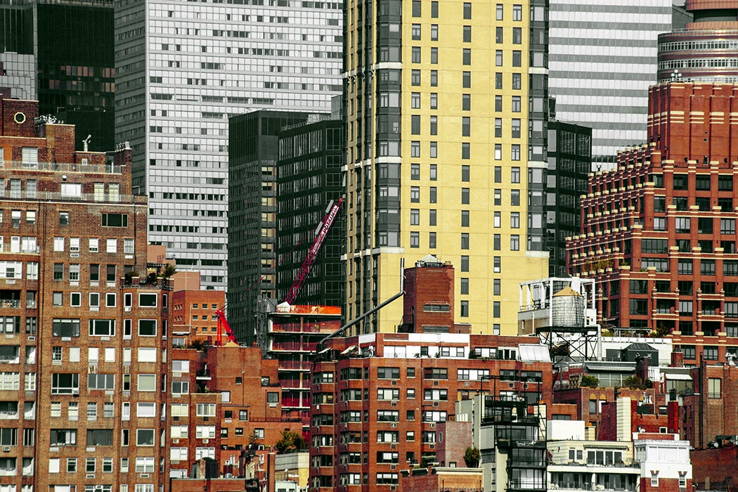 A landscape of NYC's overlapping buildings and skyscrapers with the addition of even more new construction.