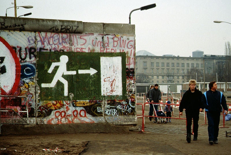 Families walking beside the Berlin Wall in 1989.