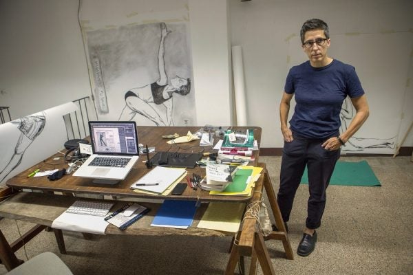 U.S. cartoonist Alison Bechdel portrayed as she works in her studio at the castle of Civitella Ranieri, central Italy, Tuesday, Sept. 2, 2014.
