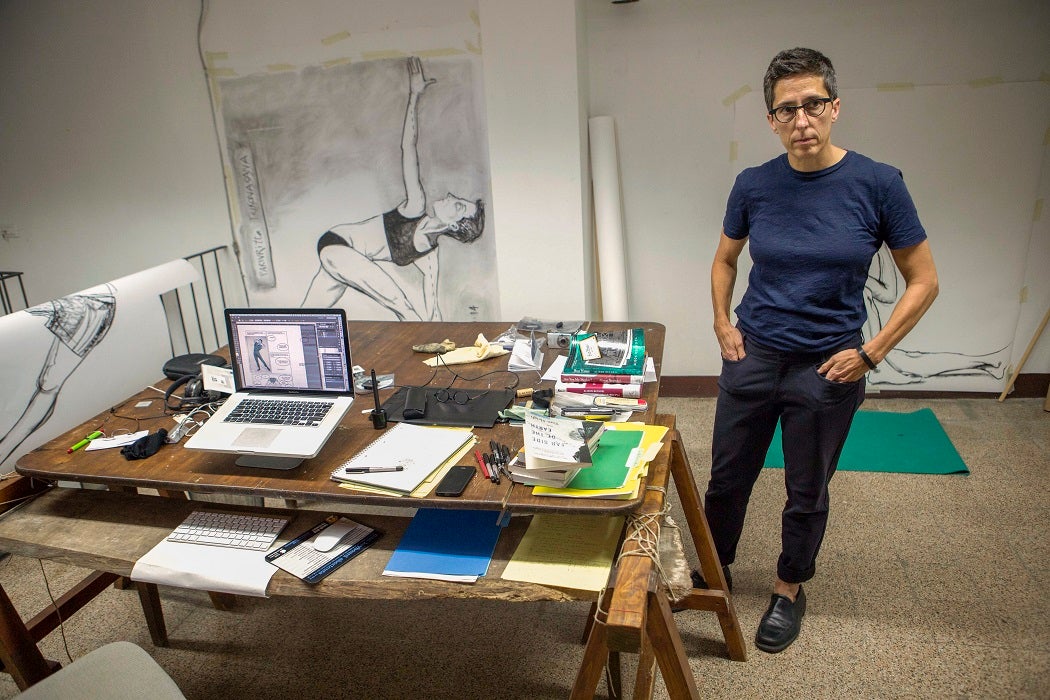 U.S. cartoonist Alison Bechdel portrayed as she works in her studio at the castle of Civitella Ranieri, central Italy, Tuesday, Sept. 2, 2014.