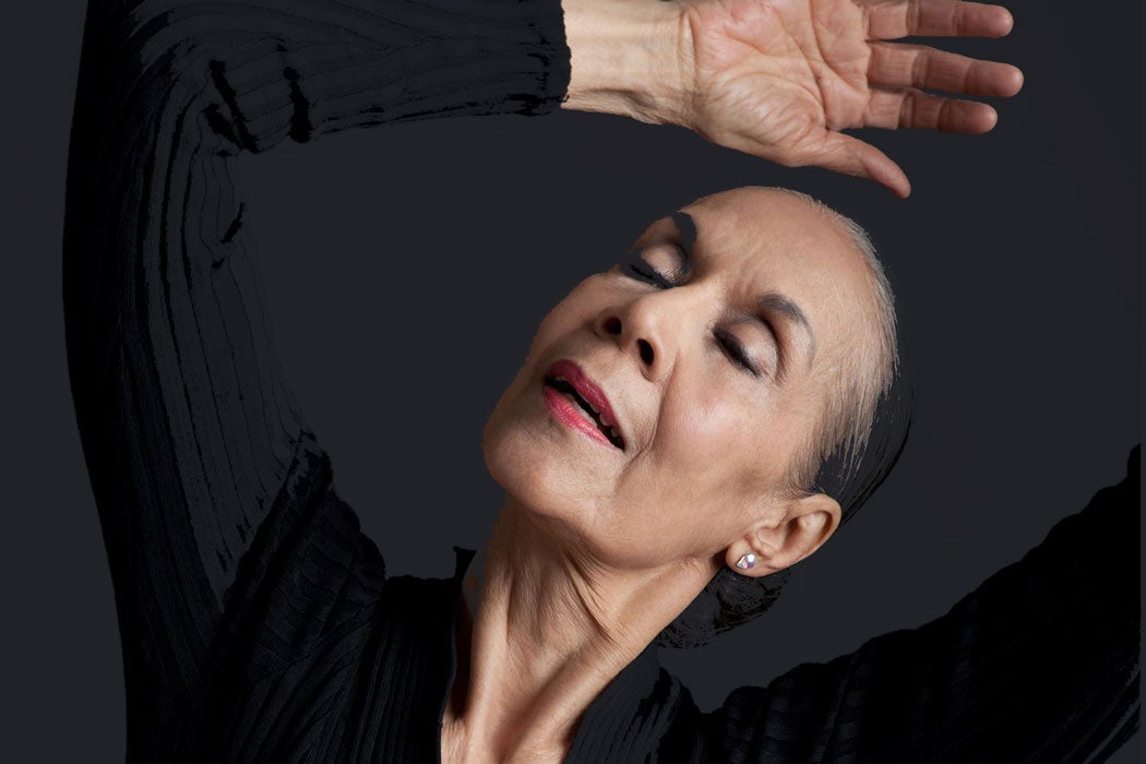 Close-up of Carmen de Lavallade with her eyes closed and her arm bent over her head in a dance pose
