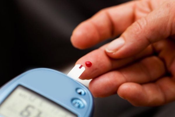 A close-up of a finger prick diabetes test