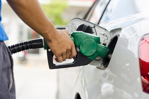Refueling Car With Gasoline Pump Nozzle, Selective Focus on pump nozzle