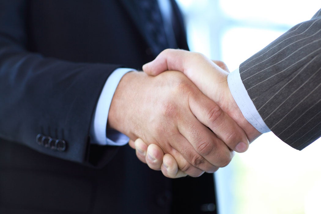 A handshake between two professionally dressed individuals