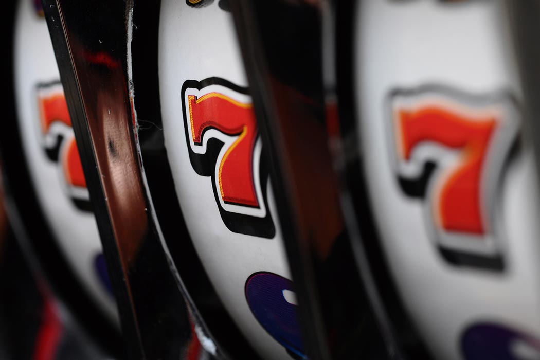 Close-up of triple 7's on the face of a slot machine