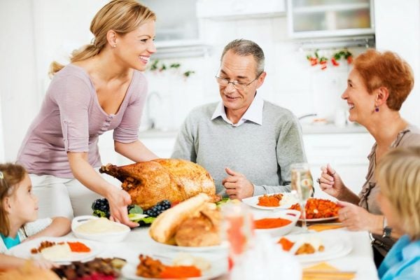 A family gathers around the table for Thanksgiving