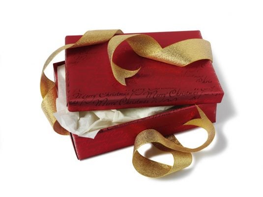 A partially opened red gift box with an undone golden ribbon