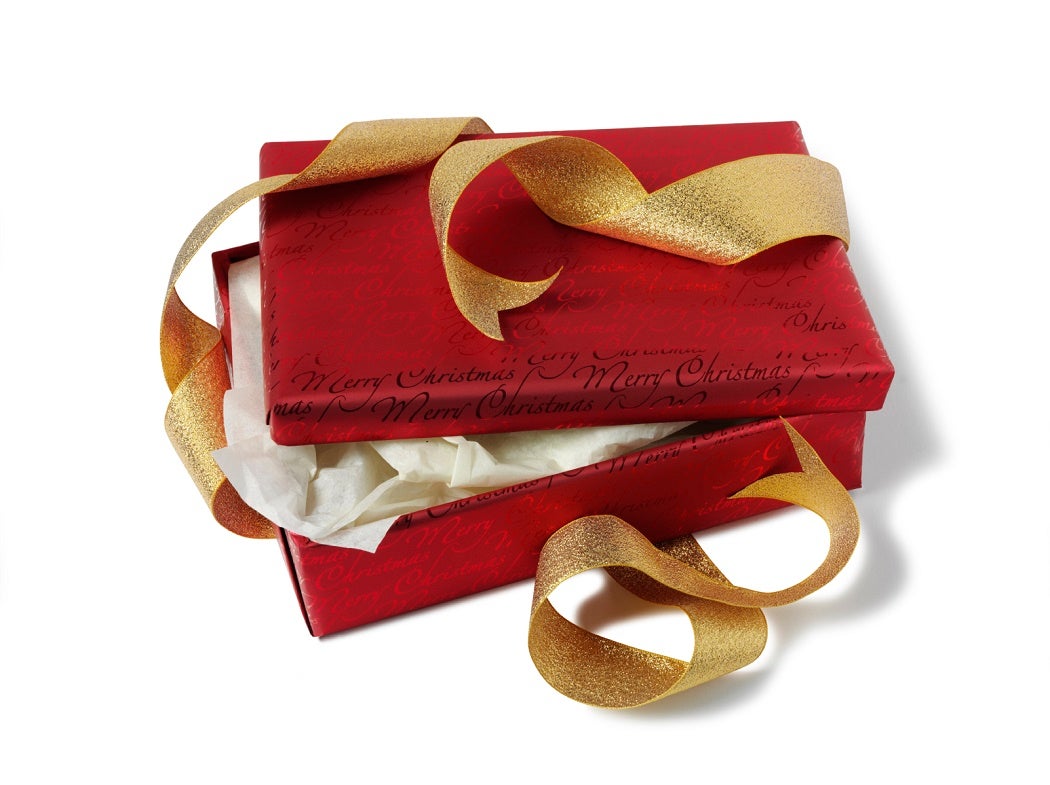 A partially opened red gift box with an undone golden ribbon