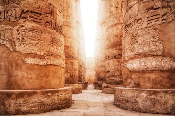 Light floods in between large Egyptian columns