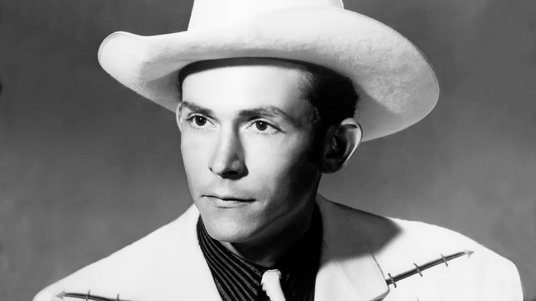 Black and white headshot of Hank Williams in a cowboy hat.
