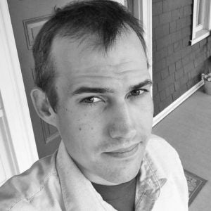 Close-up selfie of Alex Nunes in black and white