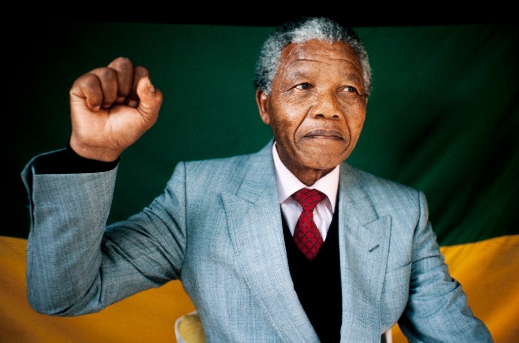 Nelson Mandela with his right fist raised