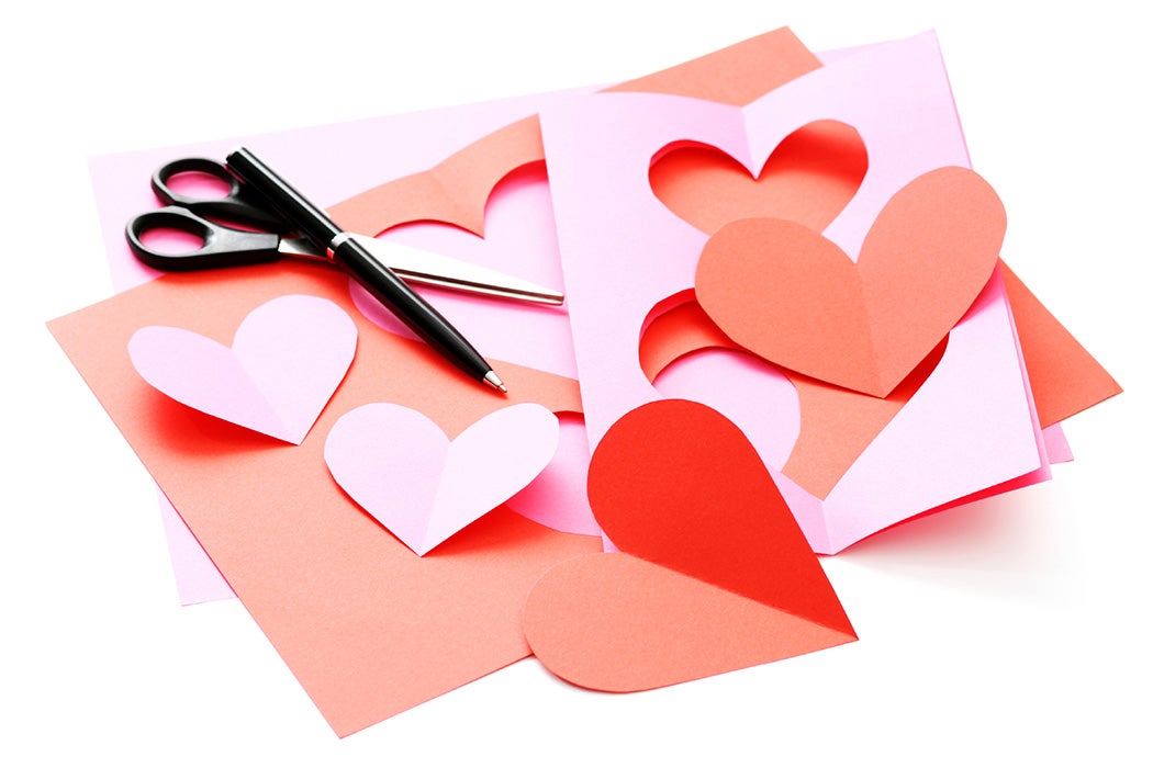 Construction paper, scissors, a pen, and cut out hearts; everything necessary for homemade Valentine's day cards