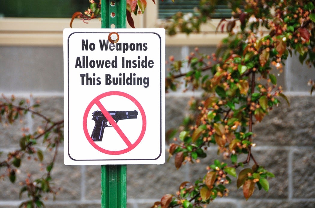 Signage reading "No Weapons Allowed Inside This Building"
