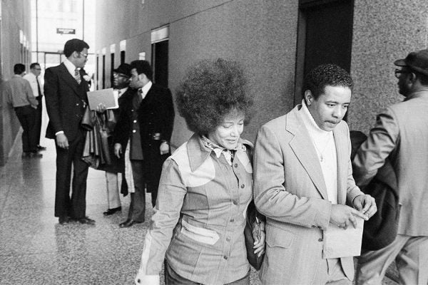 Linda Taylor, 49, the so-called "welfare queen", was sentenced to serve two-to-six years in prison in Chicago, May 13, 1977. She is shown on her way to sentencing. Taylor was convicted March 17 of theft and perjury. Man escorting her is unidentified. (AP Photo)