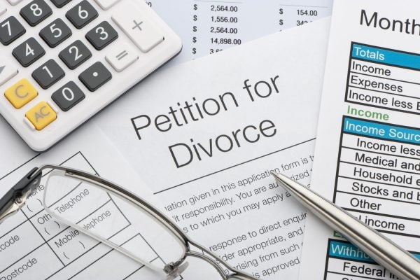 Close up of a petition for divorce with pen and calculator