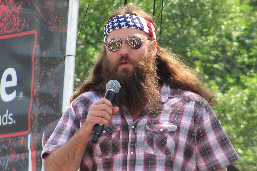 American White Trash Holding Gun Wearing Flag Stock Photo