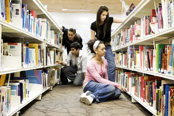 Students looking for books in a school library