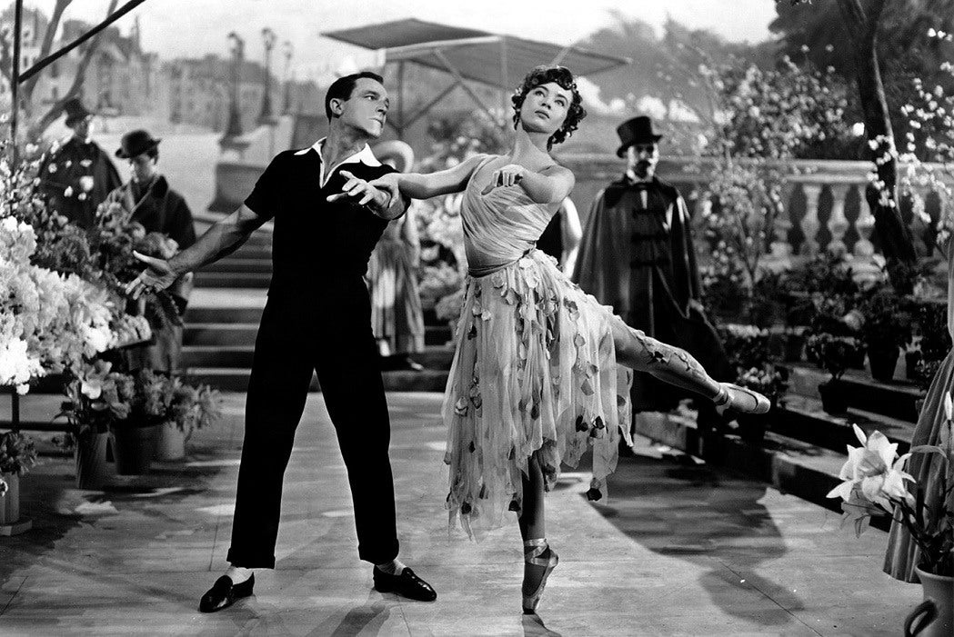 Ballerina, Leslie Caron leans on Gene Kelly's arm in "An American in Paris"