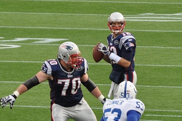 "Tom Brady and his offensive line" by Jack Newton - Flickr: Tom Brady looks downfield. Licensed under CC BY-SA 2.0 via Wikimedia Commons - http://commons.wikimedia.org/wiki/File:Tom_Brady_and_his_offensive_line.jpg#/media/File:Tom_Brady_and_his_offensive_line.jpg