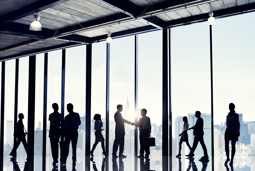 Business workers in an all glass high-rise