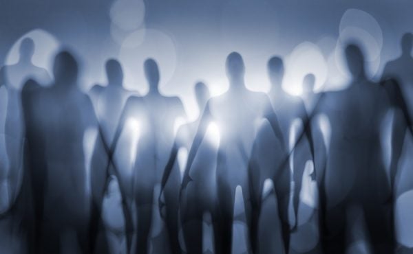 A crowd of blurry figures in cool blue light