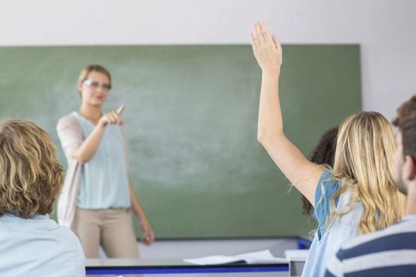 A teacher calls on a student who has raised her hand