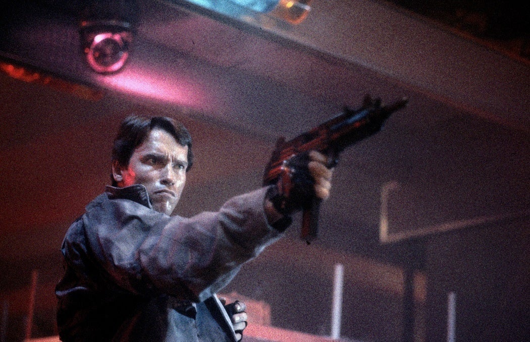 Arnold Schwarzenegger as an action hero holding a gun in 1984's The Terminator