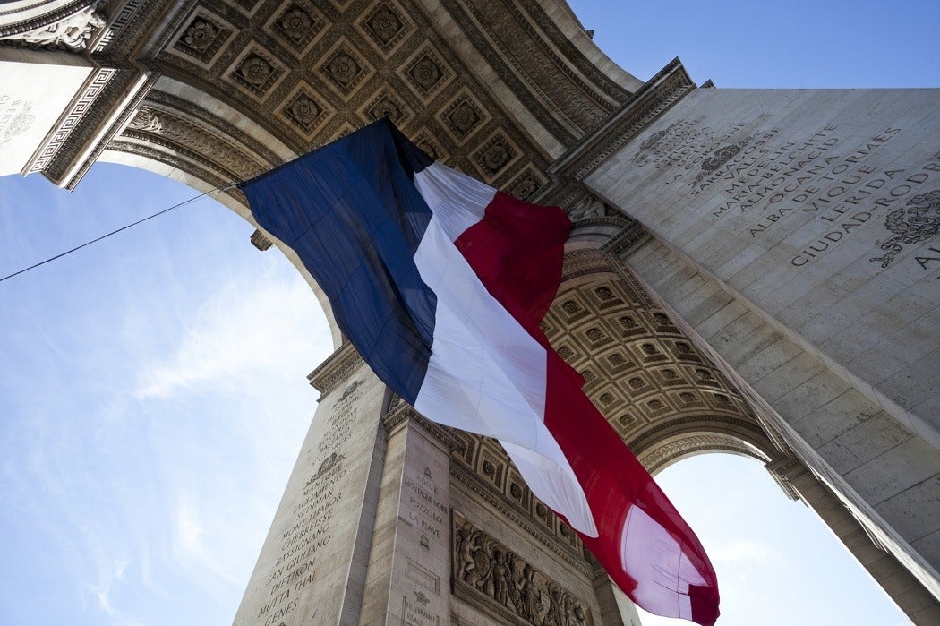 The French flag handing from the Arc de Triomphe
