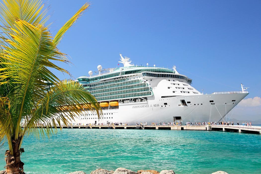 A cruise ship docks at a tropical location