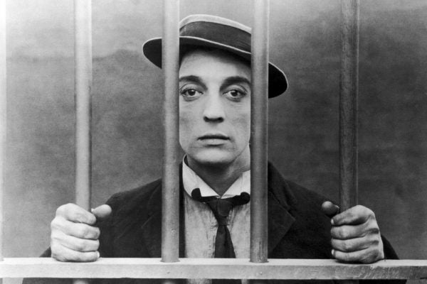 Buster Keaton behind bars in black and white