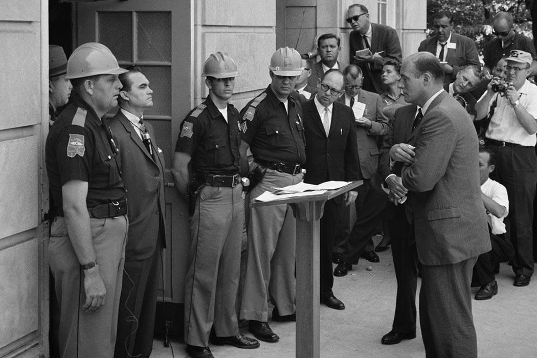 Attempting to block integration at the University of Alabama, Governor of Alabama George Wallace stands at the door of the Foster Auditorium while being confronted by United States Deputy Attorney General Nicholas Katzenbach.
