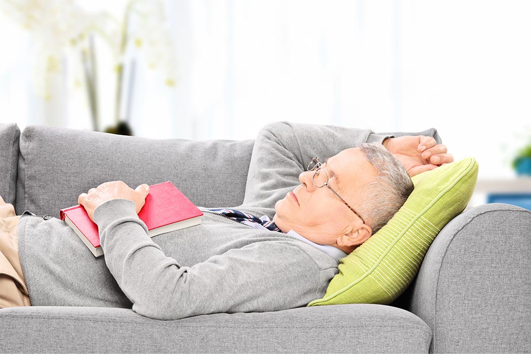 An older man napping on the couch