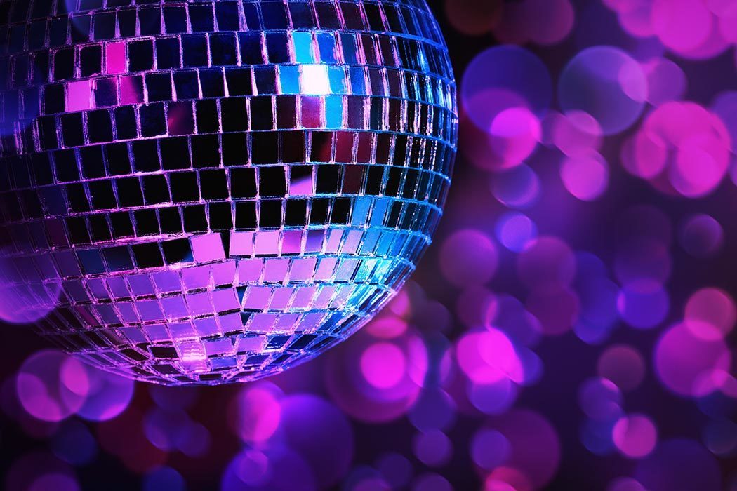 Disco ball with blurred purple lights in the background