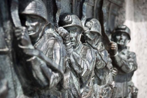 Close-up of one of the 24 bas-relief sculpture panels set into the balustrades of the main entrance to the National World War Two Memorial. This one depicts paratroopers preparing to exit their aircraft over Europe on D-Day.