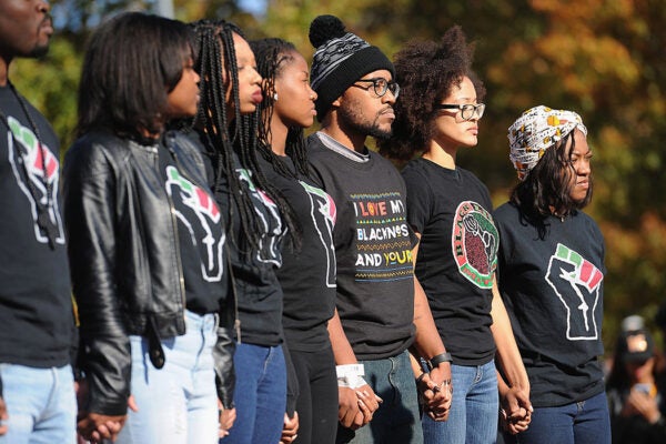 Jonathan Butler (c), a University of Missouri grad student who did a 7 day hunger strike listens during a forum speaking to students on the campus of University of Missouri - Columbia on November 9, 2015 in Columbia, Missouri.