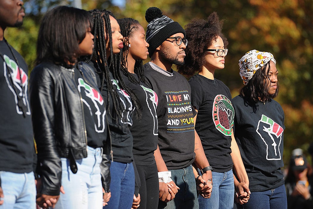 Jonathan Butler (c), a University of Missouri grad student who did a 7 day hunger strike listens during a forum speaking to students on the campus of University of Missouri - Columbia on November 9, 2015 in Columbia, Missouri.