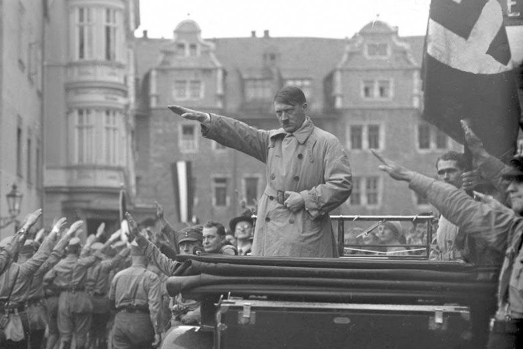 Hitler salutes marching Nazis in Weimar – Oct 1930