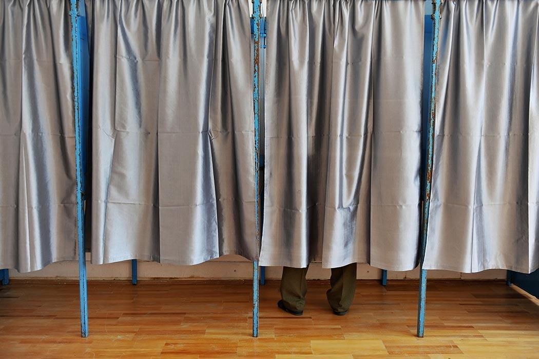Man inside a voting booth.
