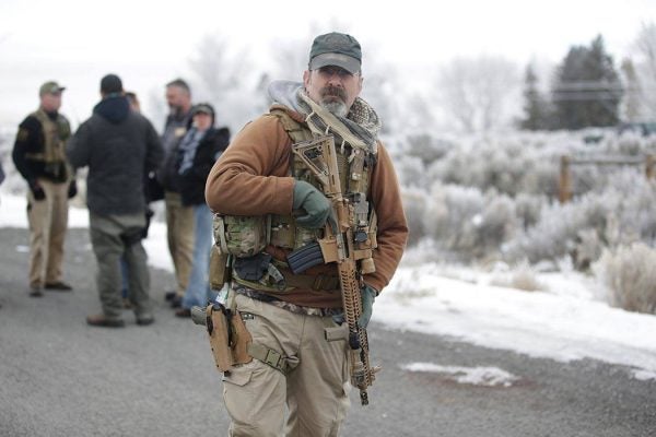 A man stands guard after members of the "3% of Idaho" group along with several other organizations arrived at the Malheur National Wildlife Refuge near Burns, Ore., on Saturday, Jan. 9, 2016. A small, armed group has been occupying the remote national wildlife refuge in Oregon for a week to protest federal land use policies. (AP Photo/Rick Bowmer)