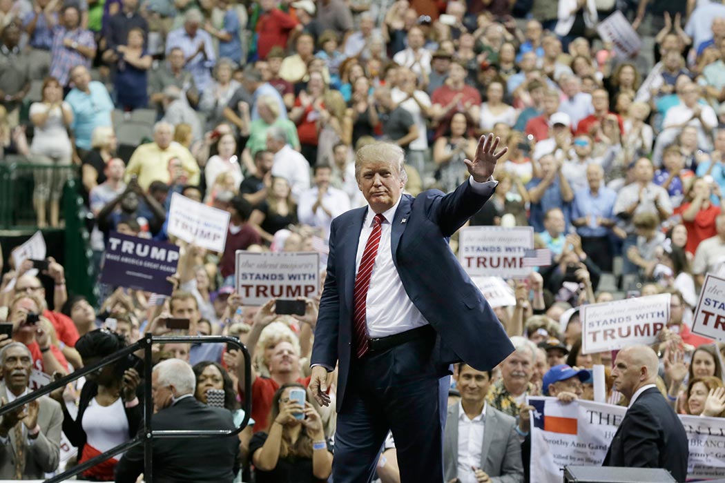 Republican presidential candidate Donald Trump waves to supporters after speaking at a campaign event in Dallas, Monday, Sept. 14, 2015. (AP Photo/LM Otero)