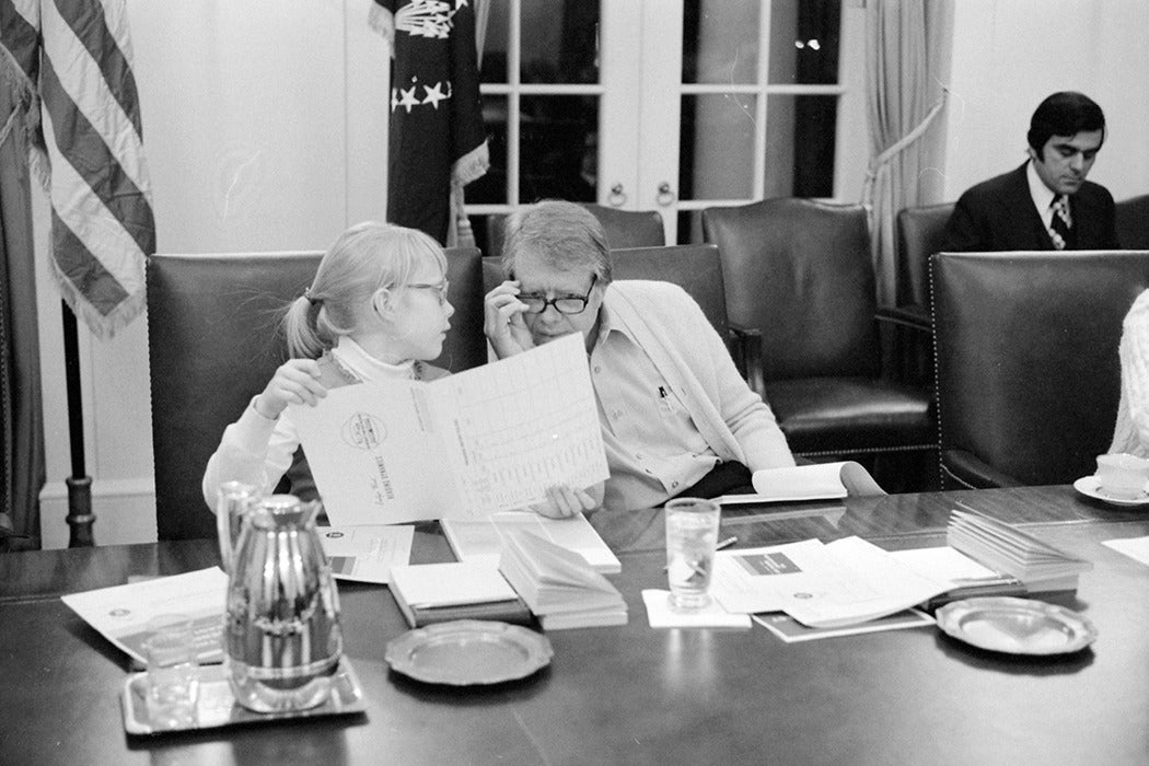 Amy Carter and Jimmy Carter participate in a speed reading course at the White House, February 22, 1977.