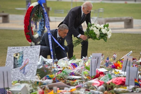 President Barack Obama with Vice President Joe Biden place flowers down during their visit to a memorial to the victims of the Pulse nightclub shooting, Thursday, June 16, 2016 in Orlando, Fla. Offering sympathy but no easy answers, Obama came to Orlando to try to console those mourning the deadliest shooting in modern U.S history. (AP Photo/Pablo Martinez Monsivais)
