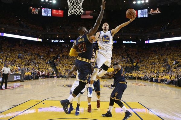 Golden State Warriors guard Stephen Curry (30) shoots against Cleveland Cavaliers forward LeBron James (23) during the first half of Game 2 of basketball's NBA Finals in Oakland, Calif., Sunday, June 5, 2016. (Ezra Shaw, Getty Images via AP, Pool)