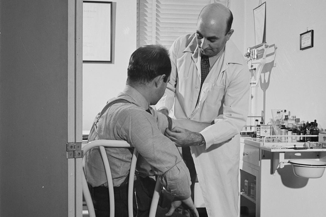 Doctor examines patient, 1942