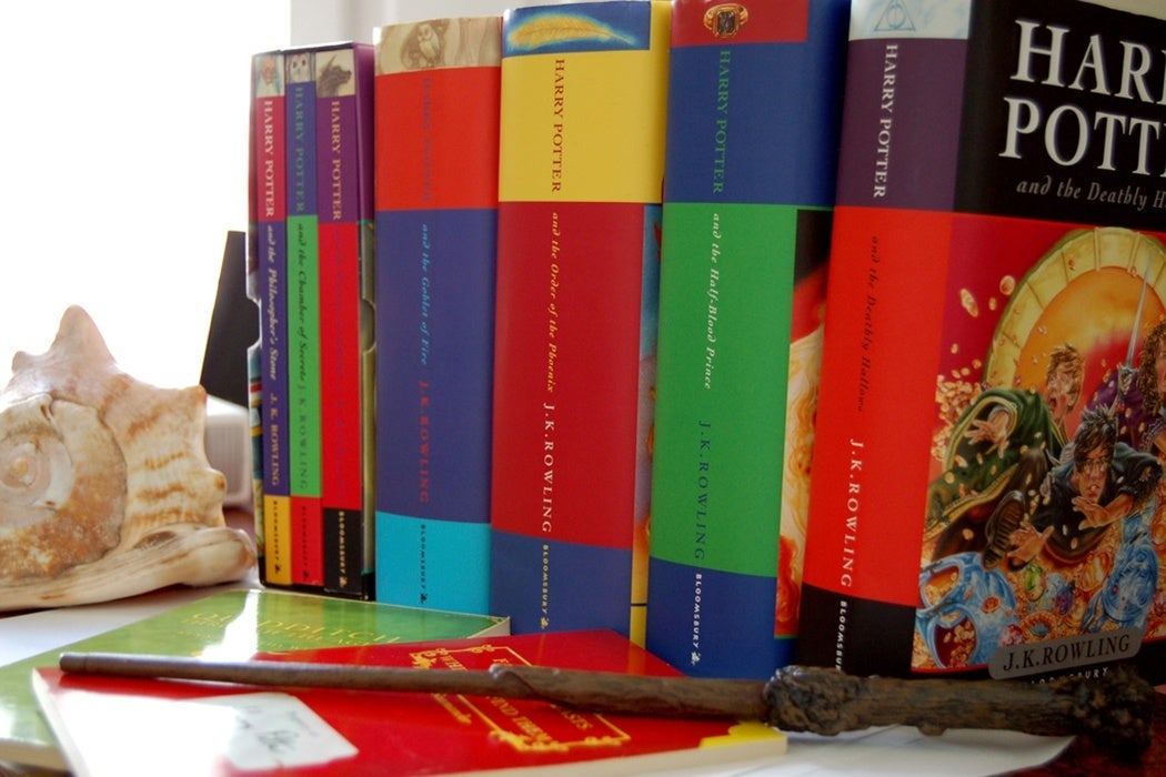 A shelf of Harry Potter books complete with a wand