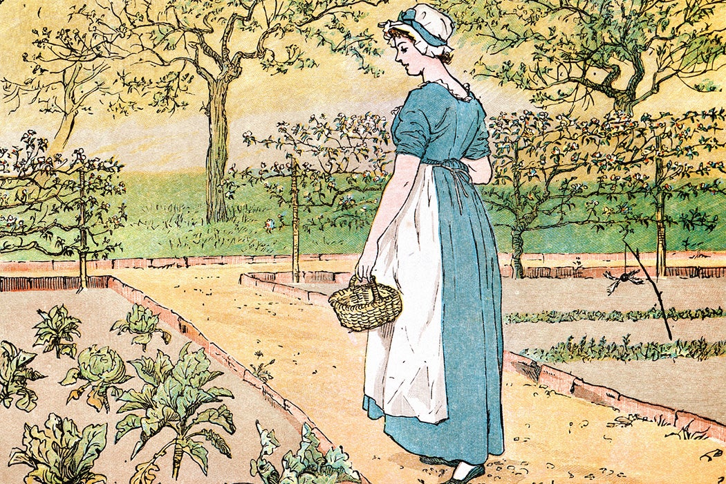 Young woman walking through a vegetable garden
