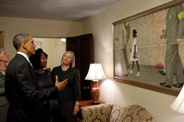 Photograph: President Barack Obama, Ruby Bridges,  and representatives of the Norman Rockwell Museum view Rockwell’s  "The Problem We All Live With,"  hanging in a West Wing hallway near the Oval Office, July 15, 2011.  Ruby Bridges is the girl in the painting. (Official White House Photo by Pete Souza)
This official White House photograph is being made available only for publication by news organizations and/or for personal use printing by the subject(s) of the photograph. The photograph may not be manipulated in any way and may not be used in commercial or political materials, advertisements, emails, products, promotions that in any way suggests approval or endorsement of the President, the First Family, or the White House. 

Source: https://flic.kr/p/a41wAb