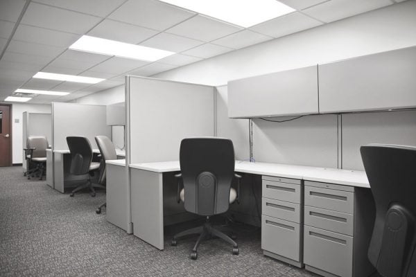 A row of empty office cubicles.