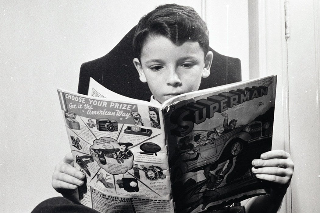 Refugee child reading Superman